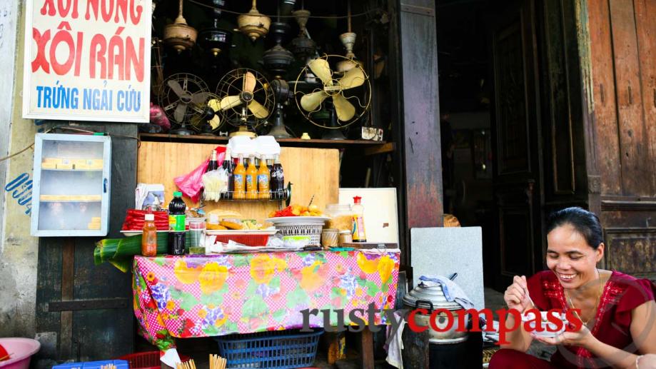 Antique fan repair shop doubles as a sticky rice vendor...