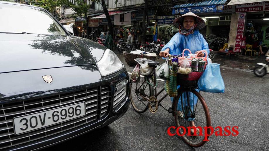 Overtaking a new Porsche, Hanoi. At street level, Hanoi's Old...