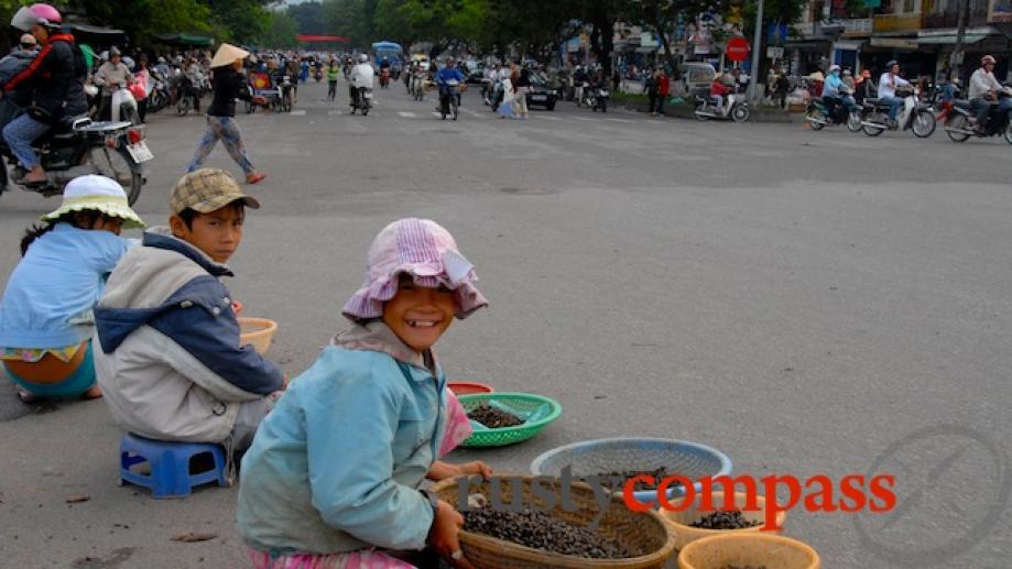 Kids selling small river snails near Dong Ba bridge, Hue