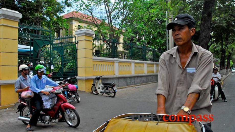Cyclo passes Saigon's former Education Department building. This block was...
