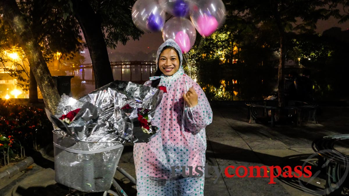 Selling flowers in the rain at midnight - Hoan Kiem Lake, Hanoi Selling flowers in the rain at midnight - Hoan Kiem Lake, Hanoi