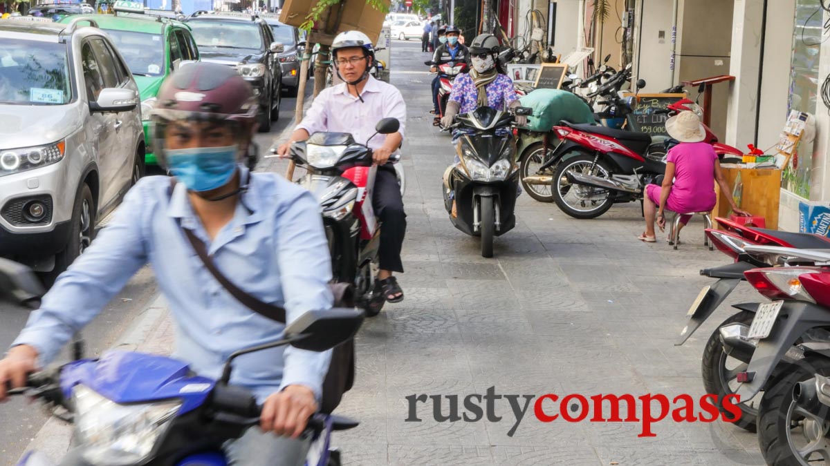 Motorbikes colonise the pavements. Saigon's tourist centre this week.