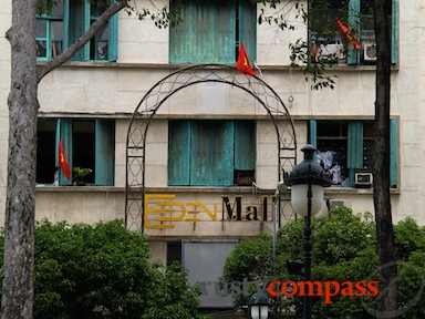 Vietnamese flags are draped from the Eden centre for the last time - marking the 35th anniversary of the communist victory. architecture,Eden Centre,Givral Cafe,Saigon,Vietnam