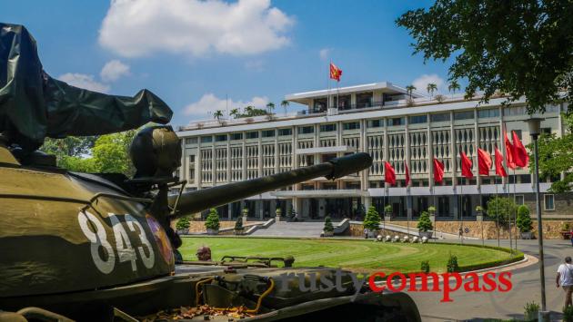 The former Presidential Palace and a replica of the tank that broke down the gates in April 1975.