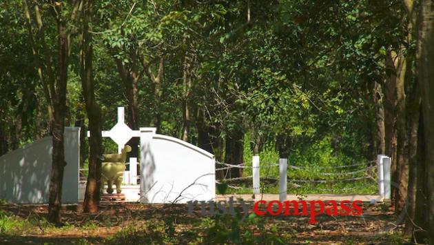 The Long Tan memorial still surrounded by rubber trees.