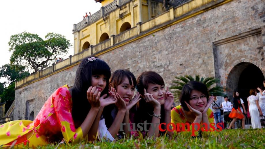 New graduates don their ao dais, the traditional Vietnamese dress,...