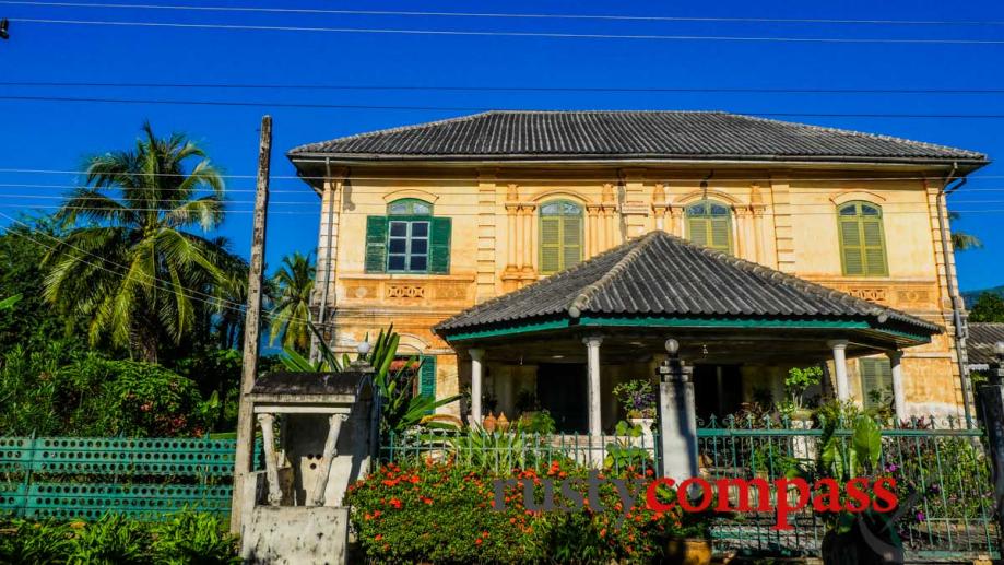 A fading Lao palace in French colonial style, in the...