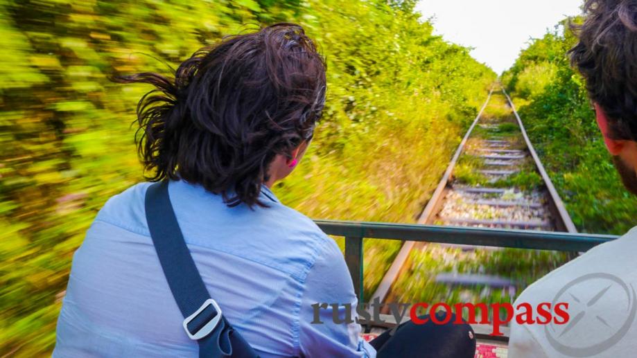 The bamboo train rumbles along at quite a clip.