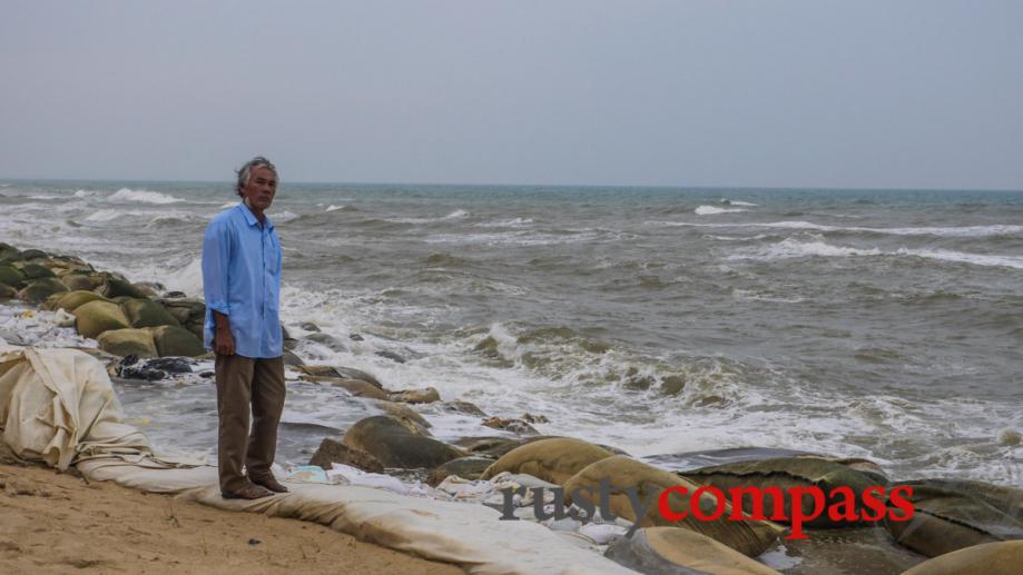 A xe om driver looks over Cua Dai beach, Hoi...