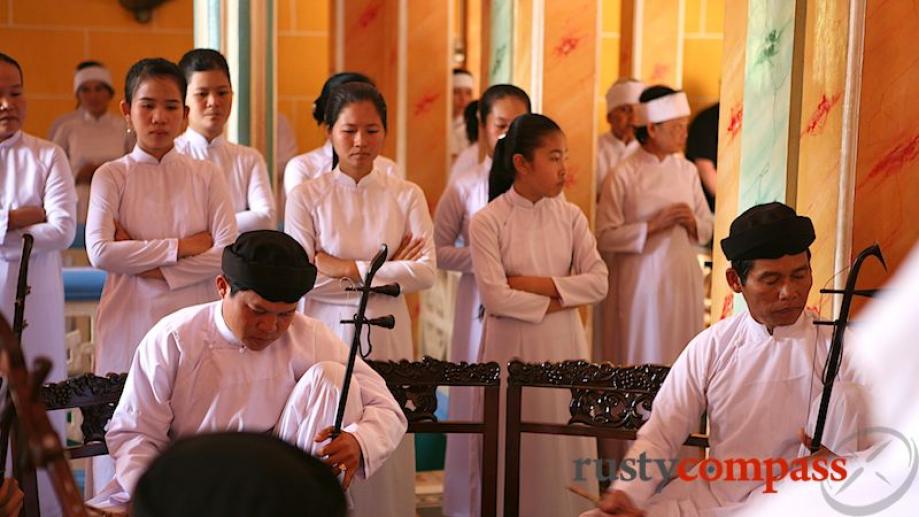 The Cao Dai service consists of prayers and chants performed...