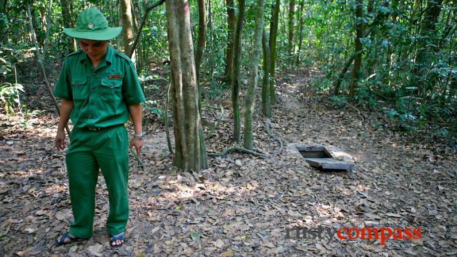 Our guide demonstrates how well camouflaged the tunnel entrances were.The...