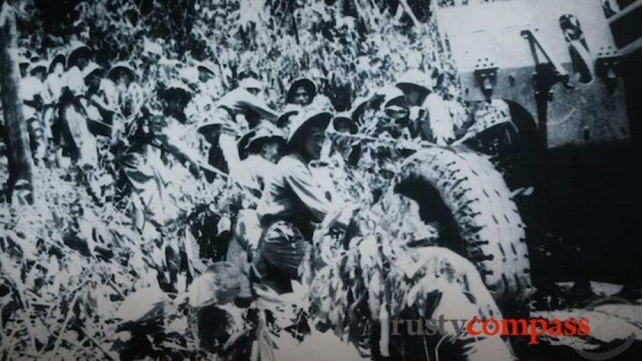 Viet Minh soldiers haul heavy guns up into the mountains...