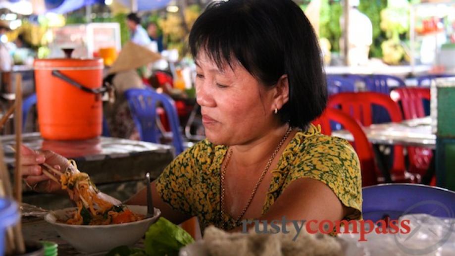 The bun cha gio stall holder heartily endorses her product.