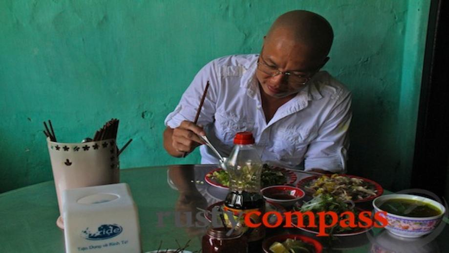 Vietnamese film director, Vu Ngoc Dan enjoys a bowl of...