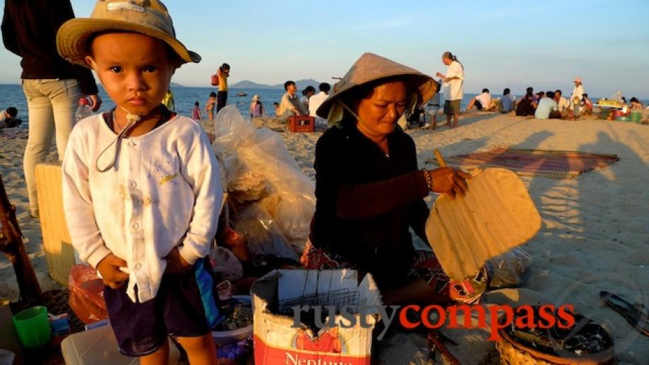 Food seller and son on An Bang beach, Hoi An