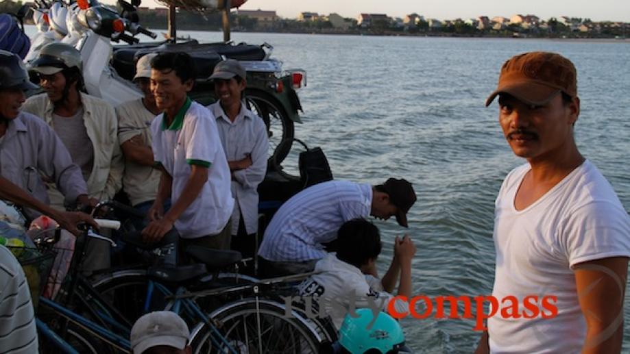 The ferry operator crossing to Cam Kim Island from Hoi...