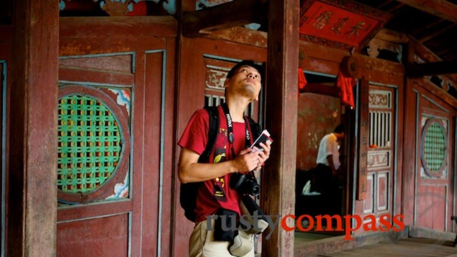 A Japanese tourist admires the timberwork of the bridge built...