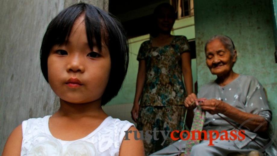 Three generations of a Hue family in the backstreets behind...