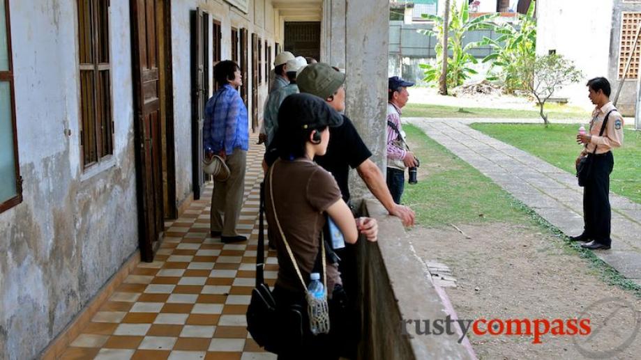 A tour guide explains the prison. The Khmer Rouge reign...